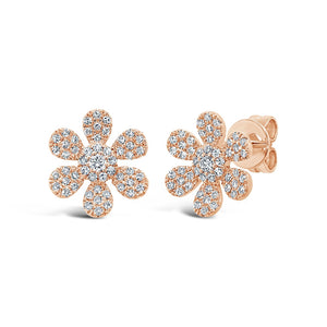 These flower earrings feature pave set round brilliant cut diamonds...