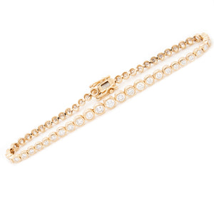 This bracelet features bezel set, round brilliant cut diamonds tota...