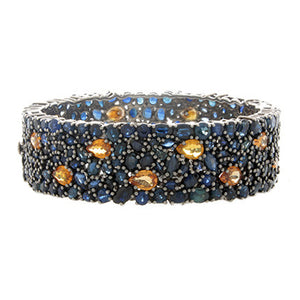 This stunning bangle features blue and orange sapphires set all the...