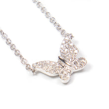 A mini white gold butterfly pendant features diamonds totaling .10c...