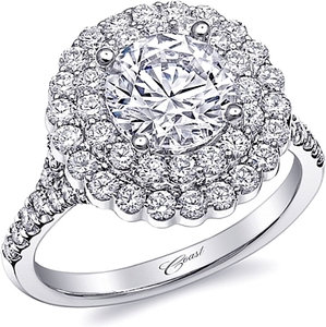 This floral inspired engagement ring features a dazzling double dia...