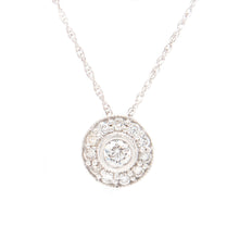 This pendant features round brilliant cut diamonds totaling a half ct.