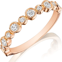 This Henri Daussi wedding band features bezel set round brilliant c...