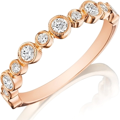 This Henri Daussi wedding band features bezel set round brilliant c...