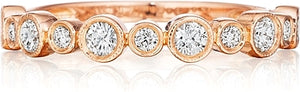 This Henri Daussi wedding band features bezel set round brilliant c...