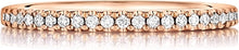 This Henri Daussi rose gold band features a single line of round br...