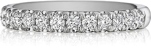This Henri Daussi wedding band features pave set round brilliant cu...
