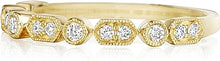 This Henri Daussi band features round brilliant bead and bezel set ...