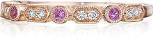 This Henri Daussi band features round brilliant bead and bezel set ...