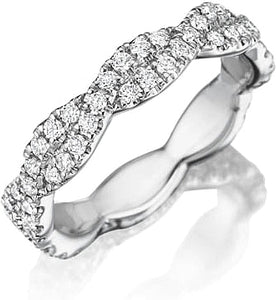 This diamond wedding band features pave set round brilliant cut dia...