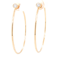 These classic hoops feature a bezel set diamond that totals .17ct