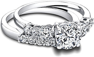 This fitted diamond wedding band by Jeff Cooper features round bril...