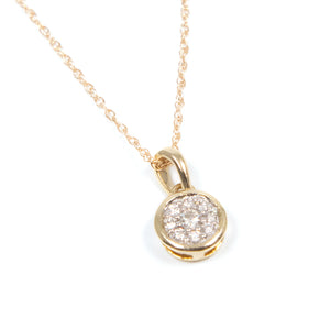 This minimalist pendant features round brilliant cut diamonds total...