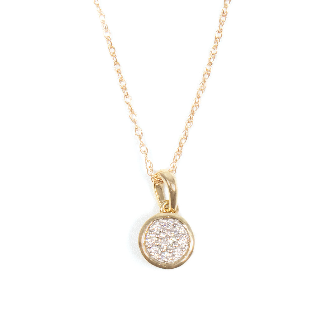 This minimalist pendant features round brilliant cut diamonds total...