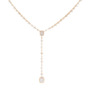 This lariat necklace features 2 emerald cut diamonds totaling .89ct...