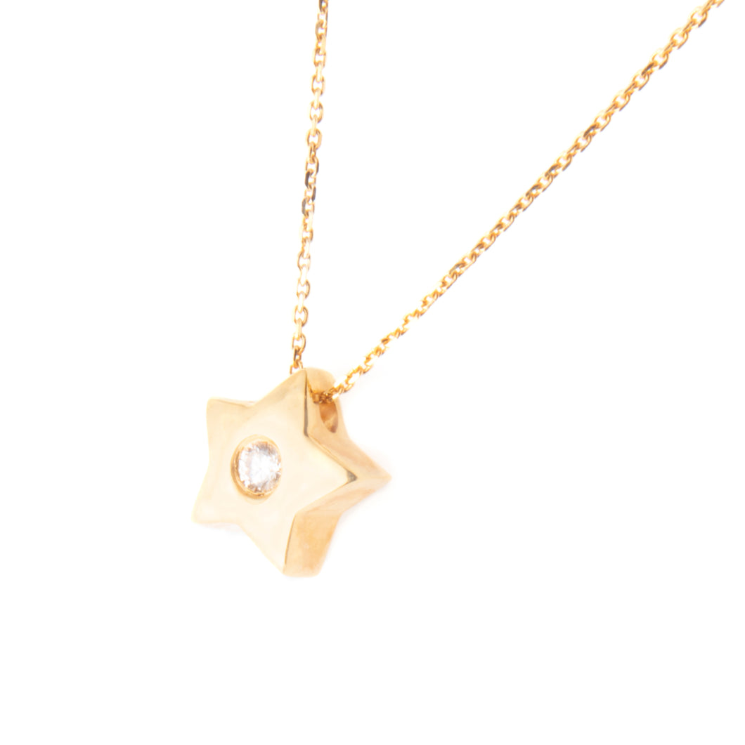 This yellow gold necklace features a small star pendant with a diam...