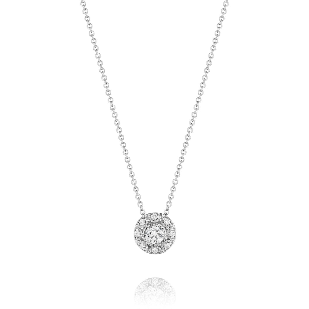 A center diamond sparkles in a bezel of Tacori crescents for truly ...