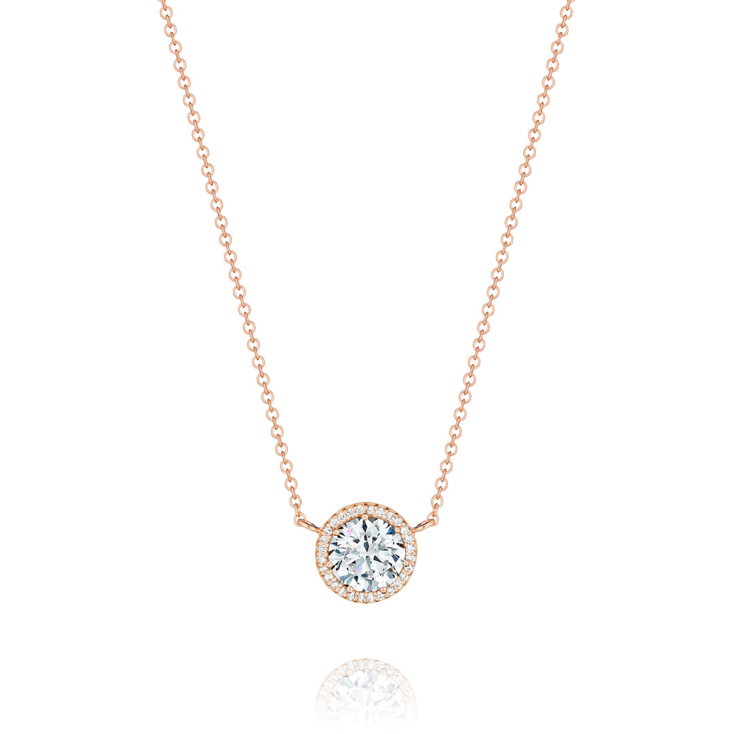 A crown of pave set diamonds encircles and blooms the perfect round...
