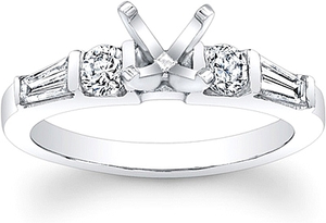This diamond engagement ring features a tapered baguette and a roun...