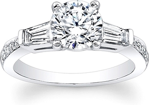 This diamond engagement ring features a tapered baguette on each si...