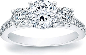 This stylish three stone engagement ring features two prong-set rou...