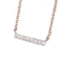 This modern and minimalist necklace features a bar pendant with dia...