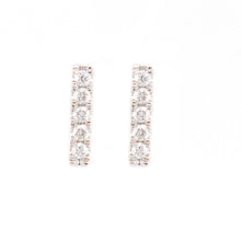 Simple and minimalist studs feature pave set diamonds totaling .06ct