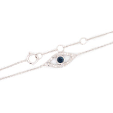 This evil eye bracelet features diamonds and a center sapphire tota...