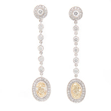 These elegant drop earrings feature 2 fancy yellow diamonds totalin...