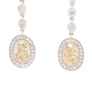 These elegant drop earrings feature 2 fancy yellow diamonds totalin...