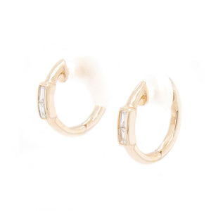 These clean and elegant huggy hoops feature baguette cut diamonds t...
